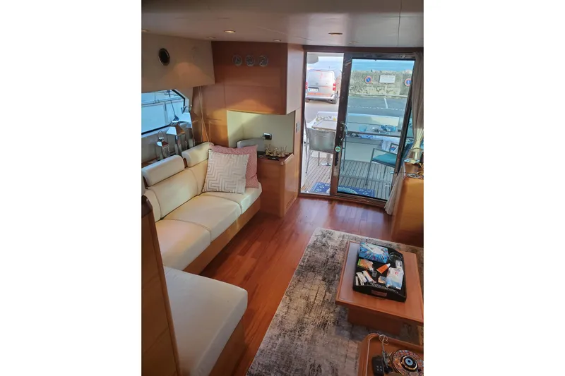  Yacht Photos Pics Luxurious interior of a 2009 Aicon 64 yacht with elegant seating and wooden flooring.