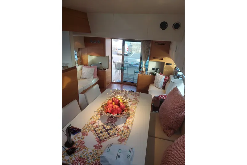  Yacht Photos Pics Luxurious interior of 2009 Aicon 64 yacht with elegant seating and decorative table setting.