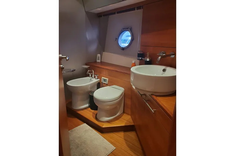 Yacht Photos Pics Luxurious 2009 Aicon 64 yacht bathroom with modern fixtures and porthole window.