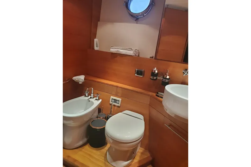  Yacht Photos Pics Luxurious 2009 Aicon 64 yacht bathroom with modern fixtures and wooden accents.