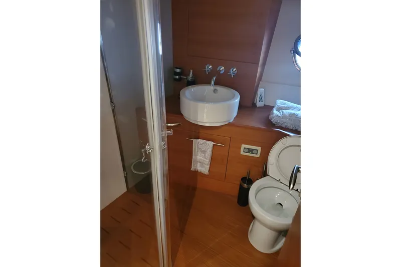  Yacht Photos Pics Luxurious bathroom in 2009 Aicon 64 yacht with modern fixtures and wooden accents.