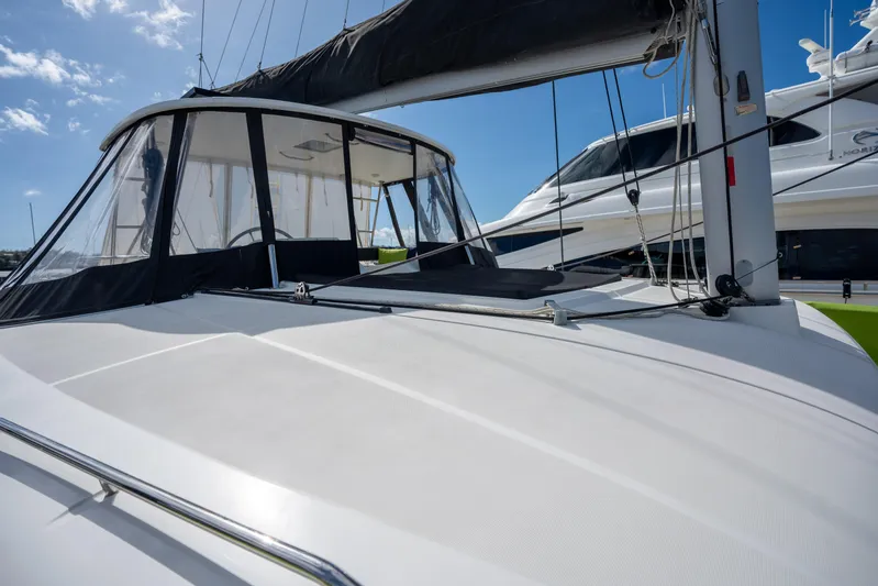  Yacht Photos Pics 2019 Lagoon 450 F catamaran with sleek design and spacious deck under clear blue sky.