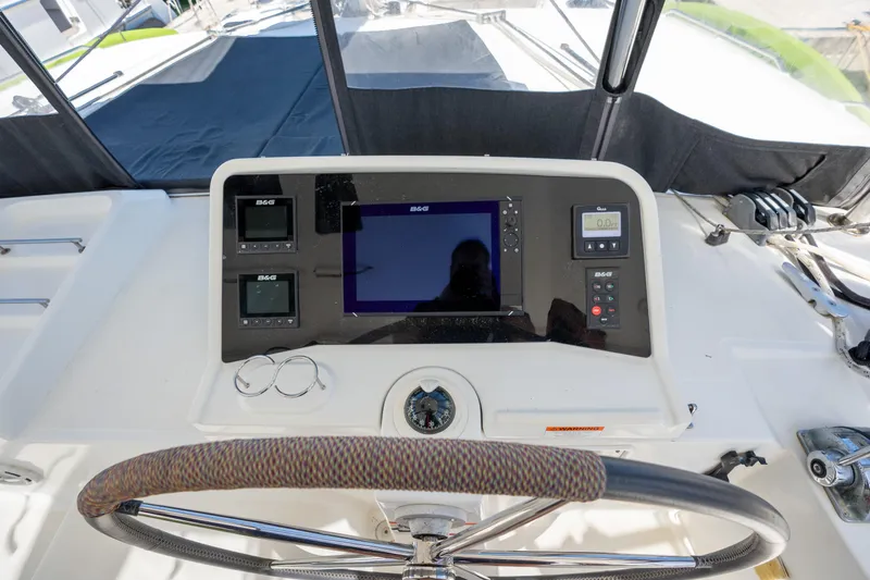  Yacht Photos Pics Helm station of 2019 Lagoon 450 F catamaran with navigation instruments and steering wheel.