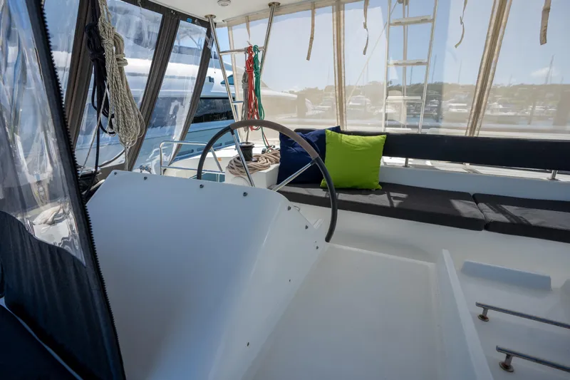  Yacht Photos Pics 2019 Lagoon 450 F yacht cockpit with steering wheel, seating, and nautical ropes.