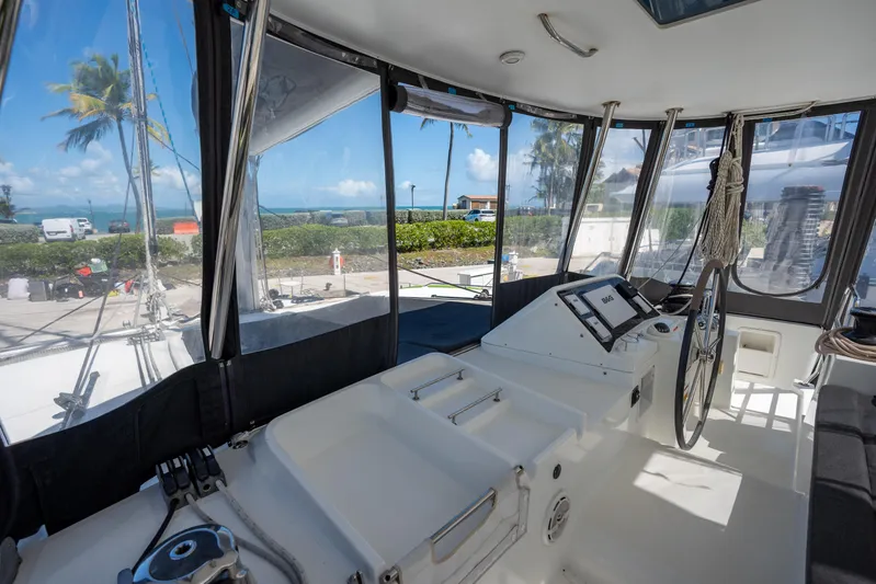  Yacht Photos Pics Interior view of 2019 Lagoon 450 F catamaran with steering wheel and ocean backdrop.