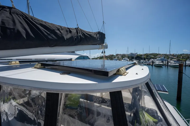  Yacht Photos Pics Lagoon 450 F 2019 catamaran with solar panels, docked in a sunny marina.
