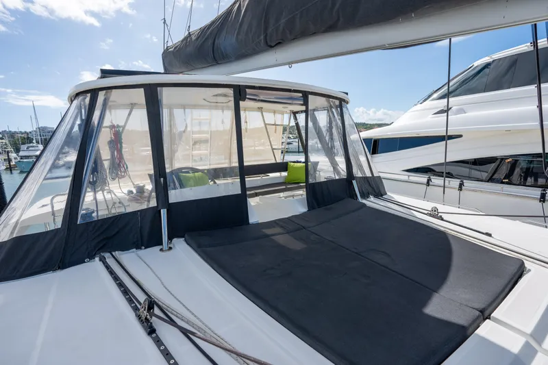  Yacht Photos Pics 2019 Lagoon 450 F catamaran with sun deck and clear enclosure in marina.