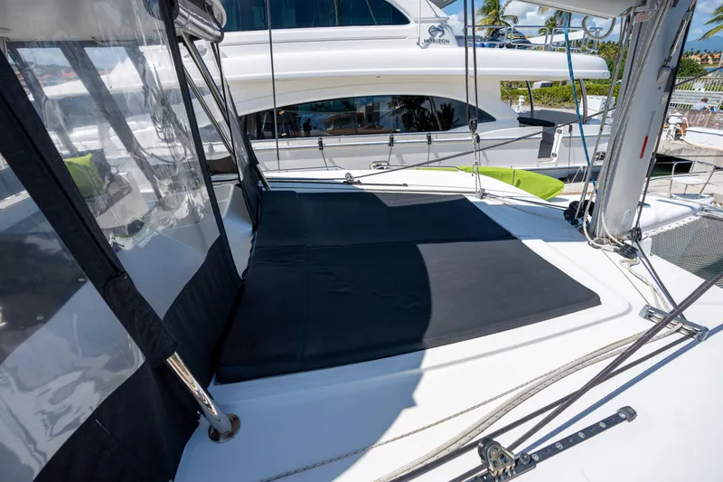  Yacht Photos Pics 2019 Lagoon 450 F catamaran deck with sunbathing area and clear skies.
