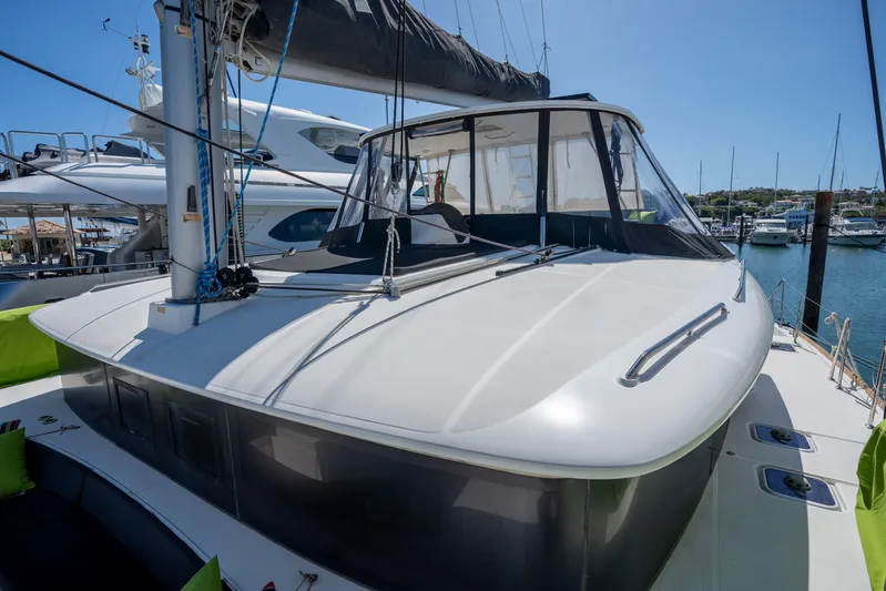  Yacht Photos Pics 2019 Lagoon 450 F catamaran docked at a marina under clear blue skies.