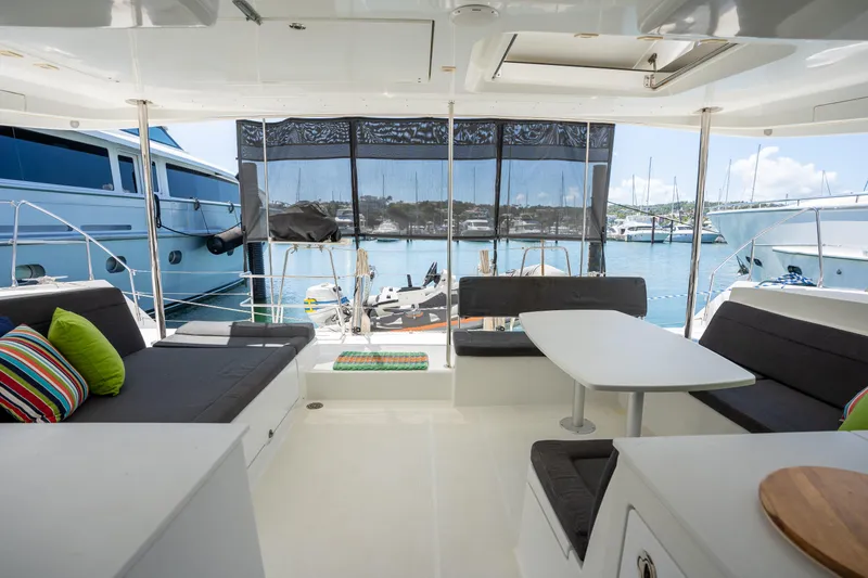  Yacht Photos Pics Spacious interior of 2019 Lagoon 450 F catamaran with modern seating and marina view.