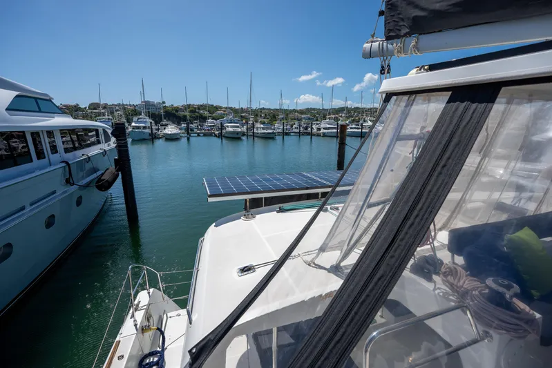  Yacht Photos Pics 2019 Lagoon 450 F catamaran docked in a marina with solar panels.