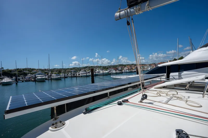  Yacht Photos Pics Lagoon 450 F catamaran with solar panels docked in a marina, 2019 model.