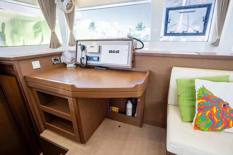  Yacht Photos Pics Interior of 2019 Lagoon 450 F yacht with navigation station and colorful cushion.