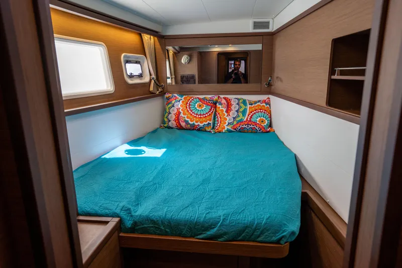  Yacht Photos Pics Cozy cabin interior of 2019 Lagoon 450 F with colorful bedding and wooden accents.