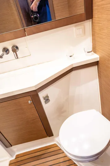  Yacht Photos Pics 2019 Lagoon 450 F yacht bathroom with modern fixtures and wooden accents.
