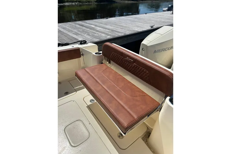  Yacht Photos Pics 2025 Scout 277 LXF boat with brown leather seating and Mercury engine at dock.