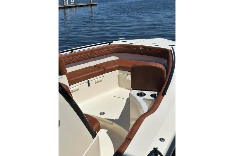 Yacht Photos Pics 2025 Scout 277 LXF boat interior with luxurious brown seating and cup holders.