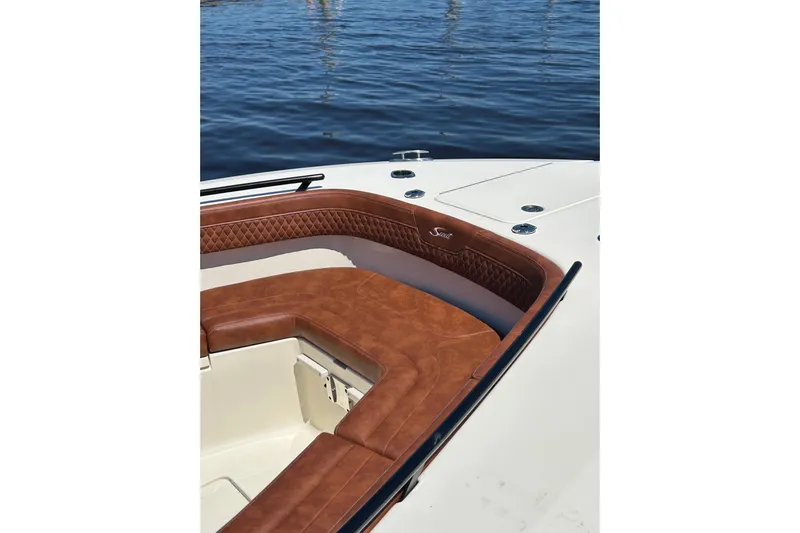  Yacht Photos Pics 2025 Scout 277 LXF boat with luxurious brown leather seating on calm water.