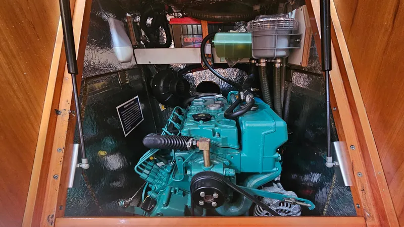 Acadia Yacht Photos Pics Engine compartment of a 2016 Hanse 415 sailboat, featuring a teal marine engine.