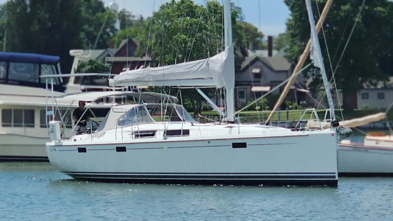 Acadia Yacht Photos Pics 2016 Hanse 415 sailboat docked in a marina, surrounded by trees and houses.