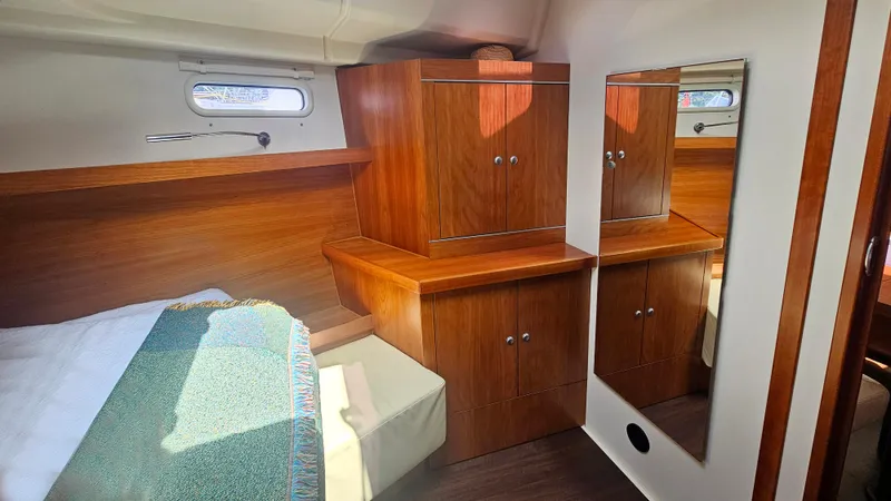 Acadia Yacht Photos Pics Luxurious cabin interior of 2016 Hanse 415 yacht with wooden cabinetry and mirror.