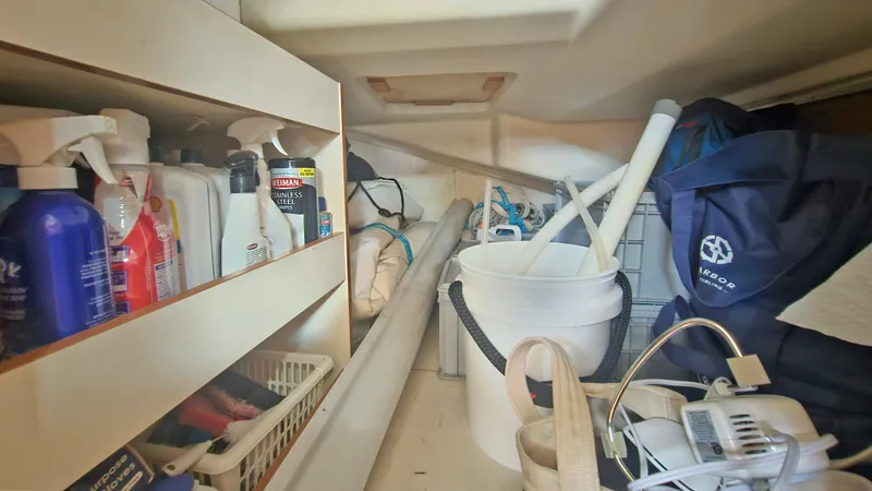 Acadia Yacht Photos Pics Storage area on a 2016 Hanse 415 yacht with cleaning supplies and equipment.