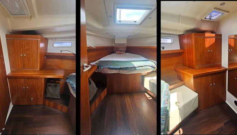 Acadia Yacht Photos Pics Interior of 2016 Hanse 415 yacht cabin with wooden cabinetry and cozy bed.
