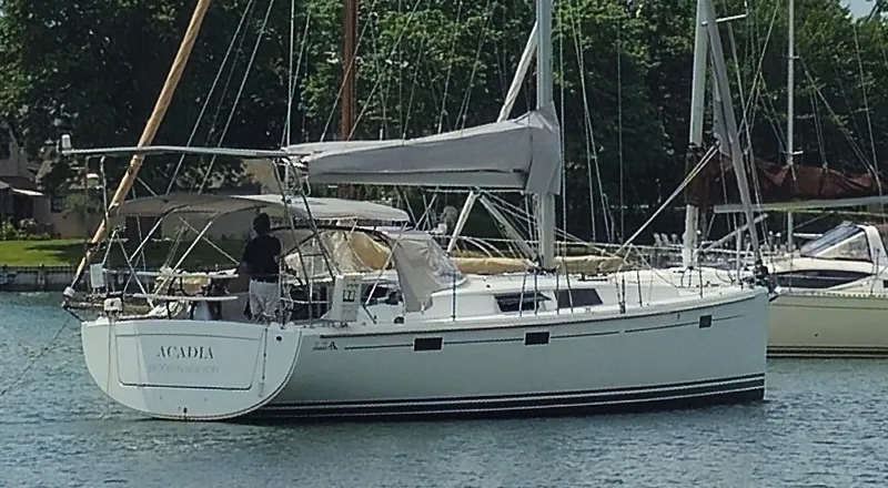 Acadia Yacht Photos Pics 2016 Hanse 415 sailboat on water, with trees in the background.