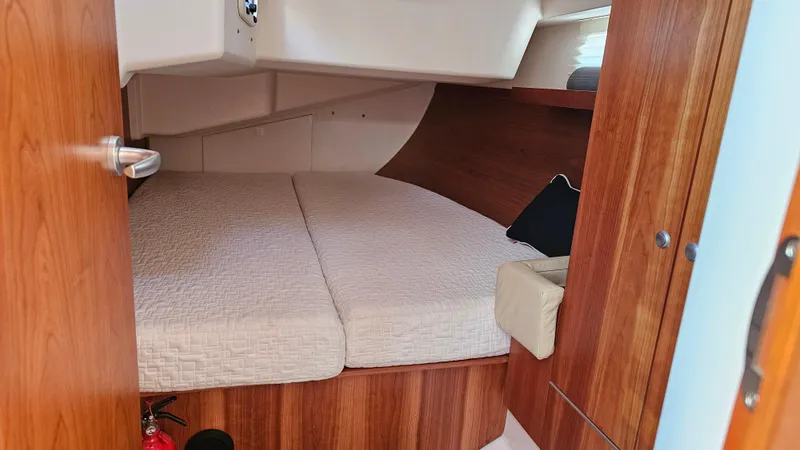 Acadia Yacht Photos Pics Cozy cabin interior of 2016 Hanse 415 yacht with wooden finish and comfortable bedding.