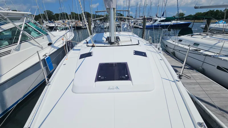 Acadia Yacht Photos Pics 2016 Hanse 415 sailboat docked at a marina, surrounded by other boats.
