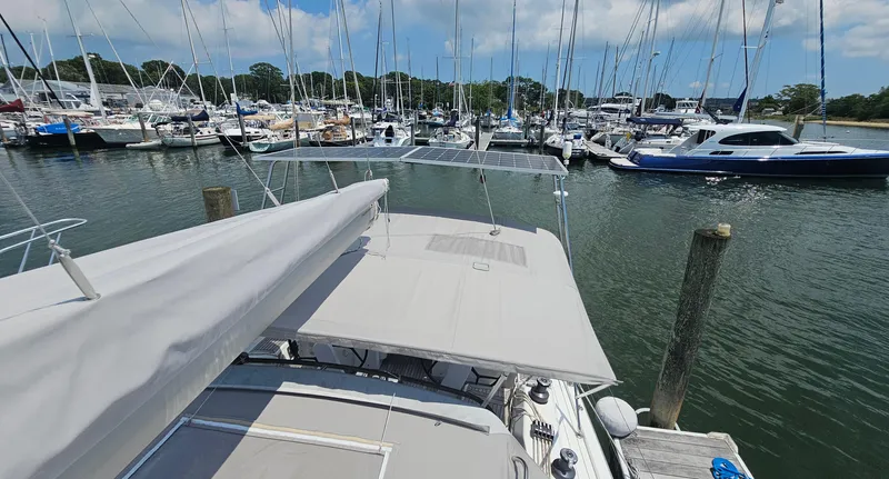 Acadia Yacht Photos Pics 2016 Hanse 415 yacht docked at marina, surrounded by sailboats under a clear sky.