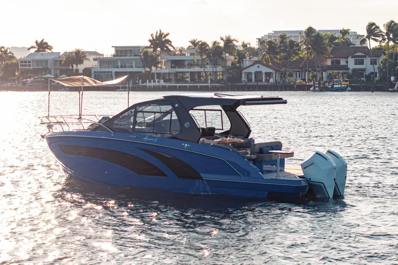  Yacht Photos Pics 2026 Hanover 347 boat on water near luxury waterfront homes.