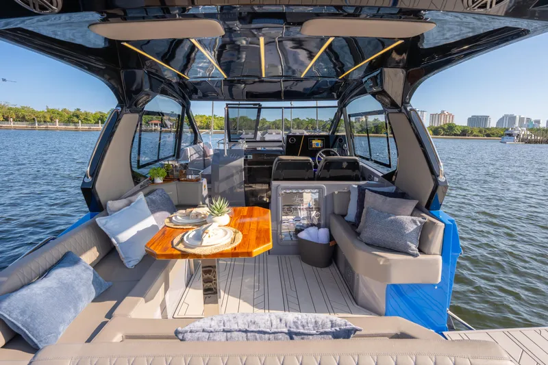  Yacht Photos Pics Luxurious 2026 Hanover 347 yacht interior with elegant seating and dining area on the water.
