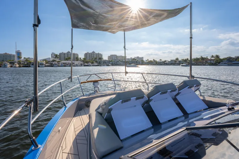  Yacht Photos Pics Luxurious Hanover 347 yacht, 2026 model, cruising on a sunny waterfront with city skyline.