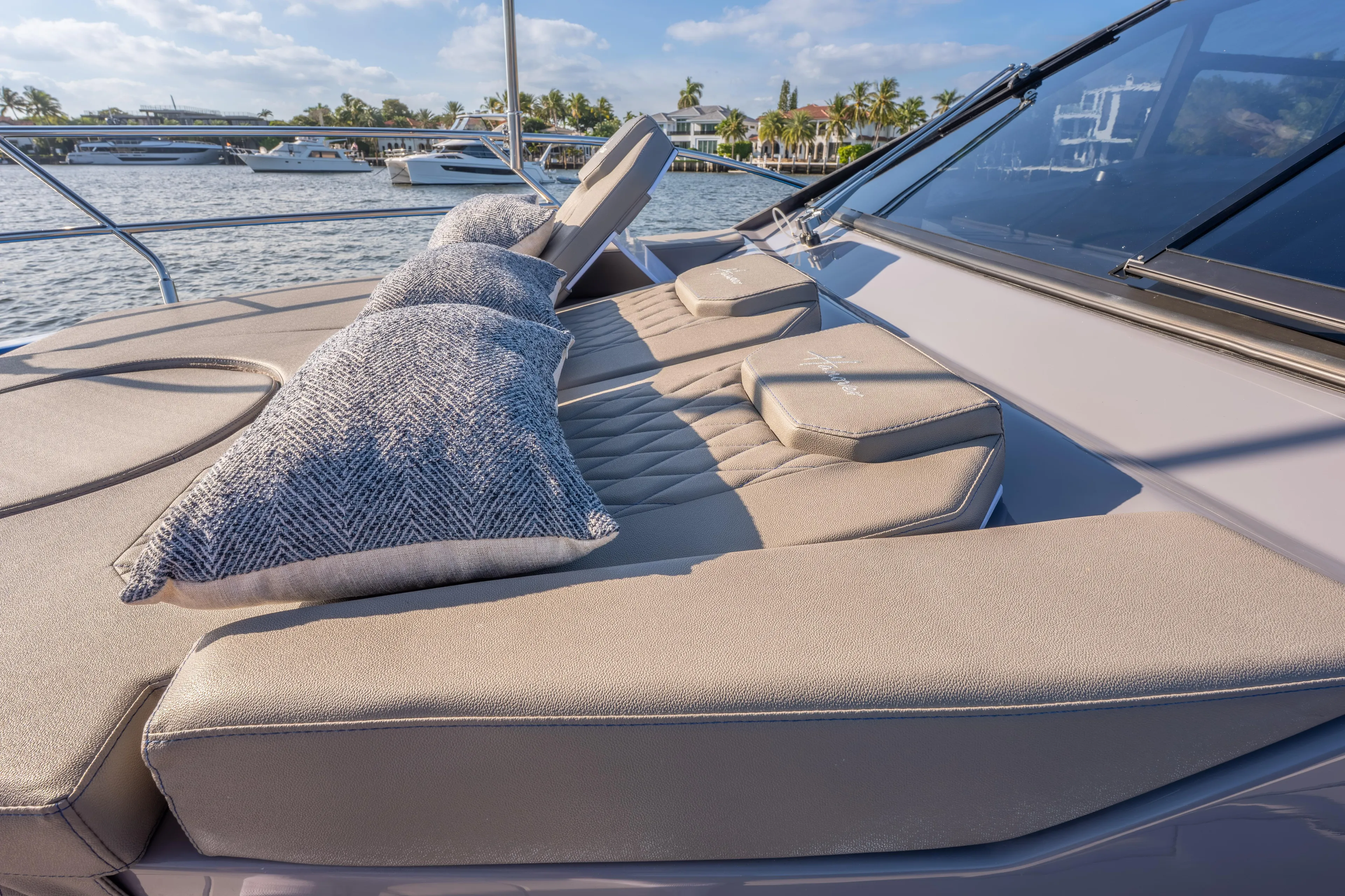  Yacht Photos Pics Luxurious Hanover 347 yacht deck with cushions, 2026 model, docked by waterfront homes.