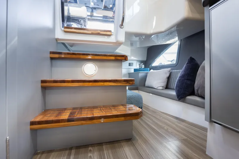  Yacht Photos Pics Interior of 2026 Hanover 347 yacht with wooden steps and cozy seating area.