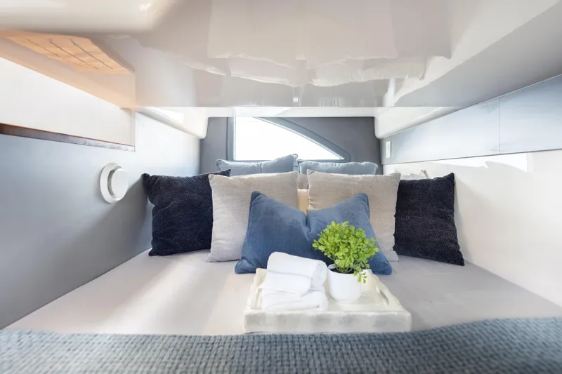  Yacht Photos Pics Luxurious cabin interior of 2026 Hanover 347 yacht with plush pillows and decor.