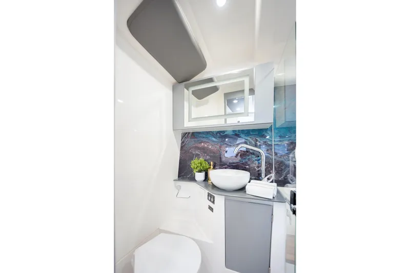  Yacht Photos Pics Modern bathroom in 2026 Hanover 347 RV with stylish sink and decorative backsplash.