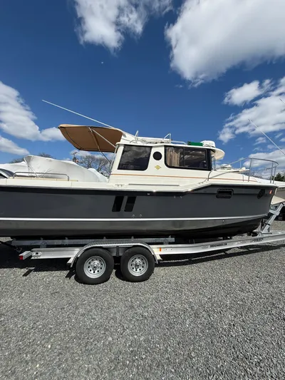  Yacht Photos Pics 2023 Ranger Tugs R-25 boat on trailer under blue sky.