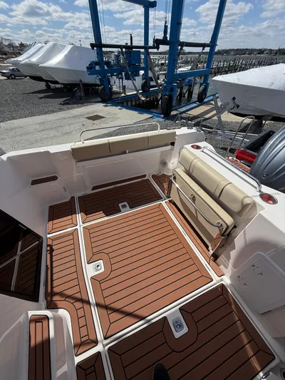  Yacht Photos Pics 2023 Ranger Tugs R-25 boat deck with wood finish, docked near blue crane.