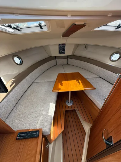  Yacht Photos Pics 2023 Ranger Tugs R-25 interior with cozy seating and wooden table.