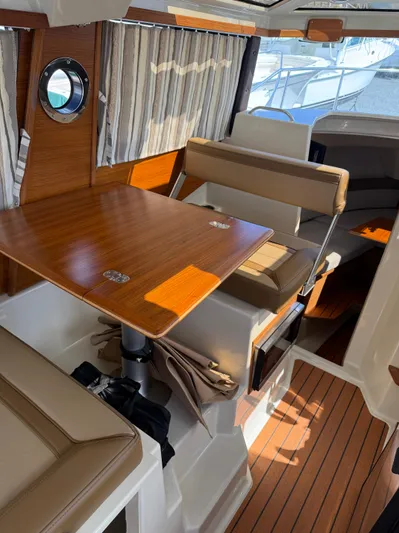  Yacht Photos Pics 2023 Ranger Tugs R-25 interior with wood accents and seating.