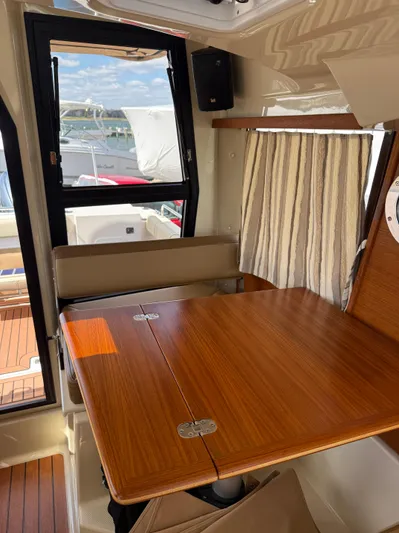  Yacht Photos Pics Interior of 2023 Ranger Tugs R-25 with wooden table and window view.