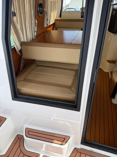  Yacht Photos Pics 2023 Ranger Tugs R-25 interior with tan seating and wood flooring.