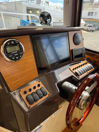  Yacht Photos Pics 2023 Ranger Tugs R-25 helm with modern controls and wood accents.
