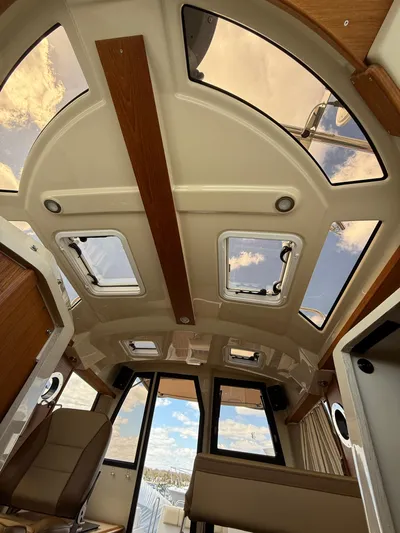 Yacht Photos Pics 2023 Ranger Tugs R-25 interior with panoramic windows and modern design.