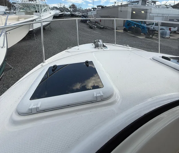  Yacht Photos Pics 2023 Ranger Tugs R-25 boat deck with hatch, docked in a marina.