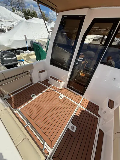  Yacht Photos Pics 2023 Ranger Tugs R-25 boat interior with teak flooring and seating area.