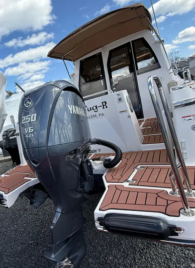  Yacht Photos Pics 2023 Ranger Tugs R-25 boat with Yamaha 250 V6 engine, docked under a blue sky.