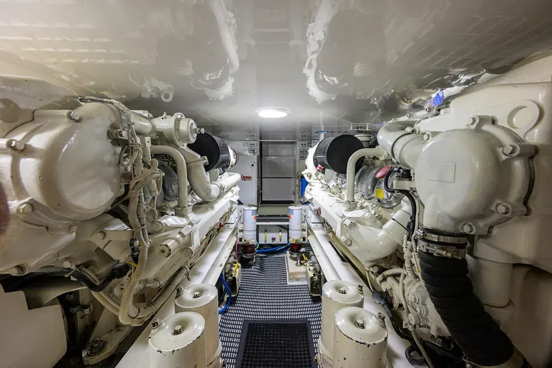 Island Girl Yacht Photos Pics Engine room of a 2004 Viking 48 Convertible yacht, showcasing dual engines and mechanical components.